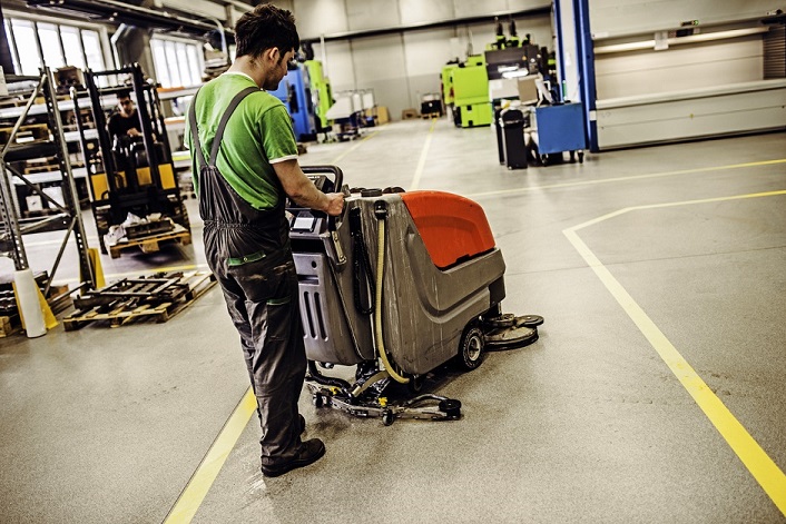 Man Using Industrial Walk-Behind Scrubber